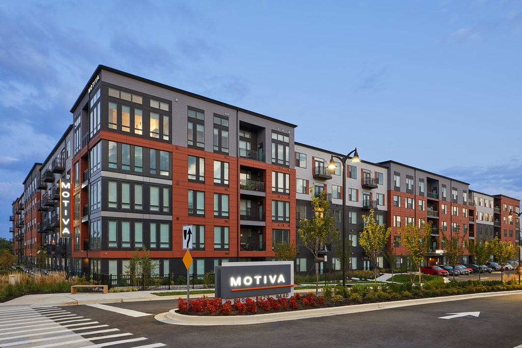 A Motiva apartment complex is shown with a street in front.