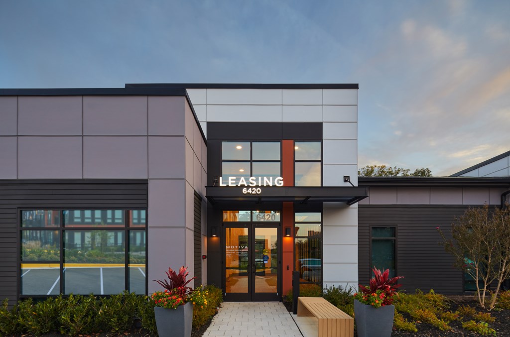 A modern building with a leasing sign on the front.