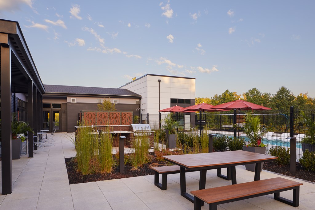 A patio with a table and chairs and a sign that says "PATIO".