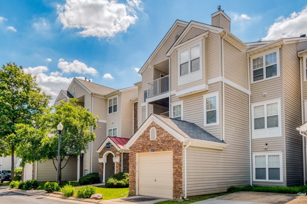 A large apartment building with a garage door in front at Park at Winterset Apartments, Owings Mills, Maryland