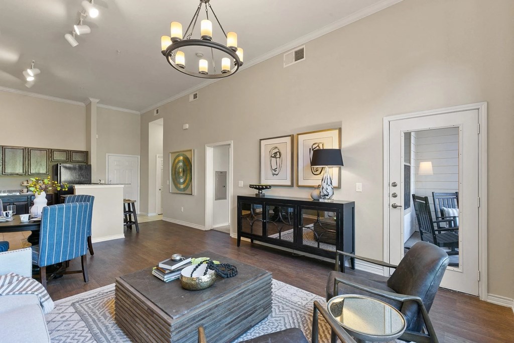A living room with a blue chair and a coffee table at Prairie Crossing, Farmers Branch, 75244