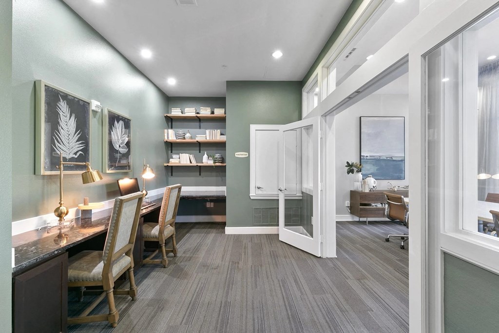 A room with a long table and chairs with a green wall and a white door at Prairie Crossing, Farmers Branch, TX
