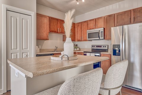 A kitchen with a table and chairs.