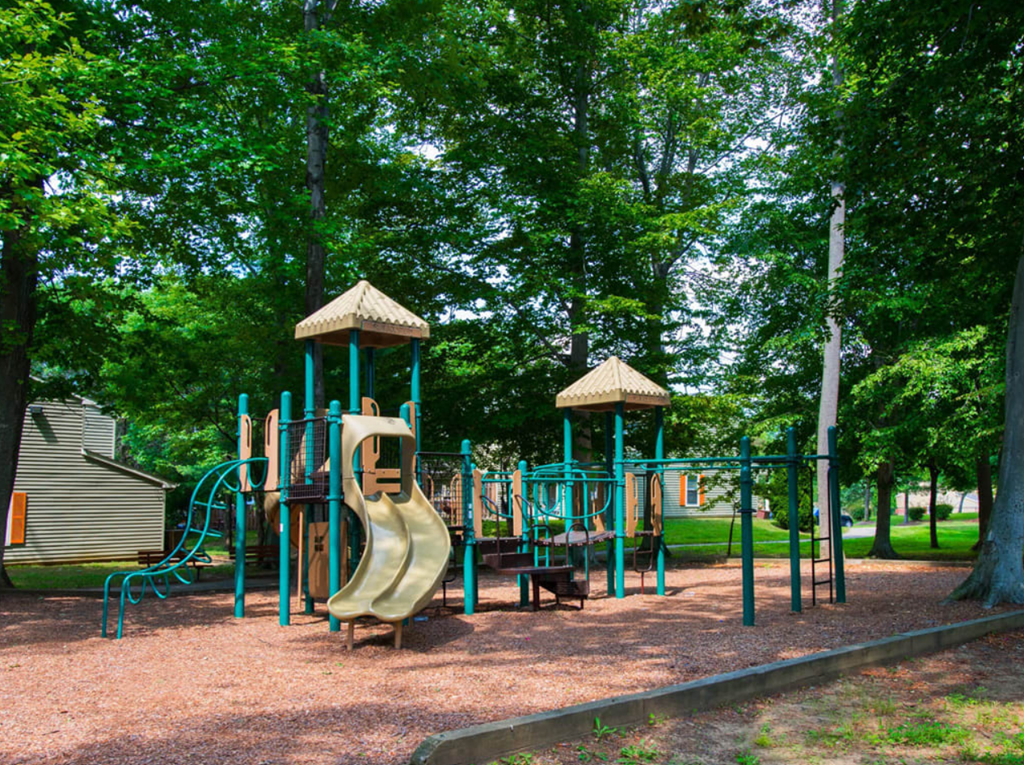 a playground with a slide in a park at Villages at Morgan Metro, Landover, MD