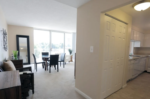 A living room with a dining table and chairs is shown.