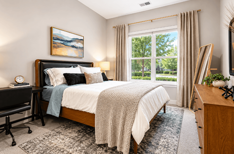 Bedroom with large window and neutral decor at The Terrace Apartments, Frederick, 21701