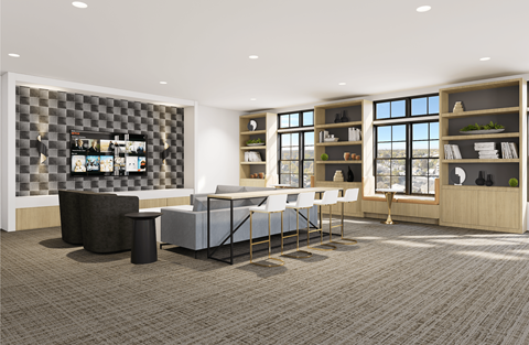 A modern living room with a grey carpet and a black and white checkered wall.