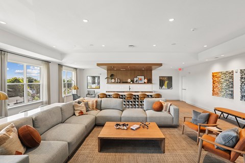 A living room with a grey sofa and a wooden coffee table.