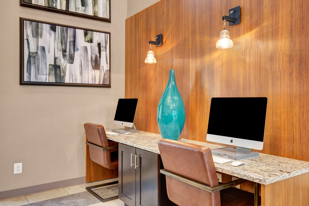 two computers sitting on a desk in a office with a vase at Villages at Morgan Metro, Landover, 20785