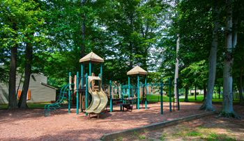 a playground with a slide in a park at Villages at Morgan Metro, Landover