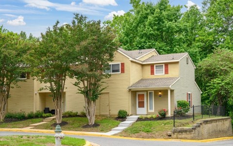 A house with a red door and a brown roof.