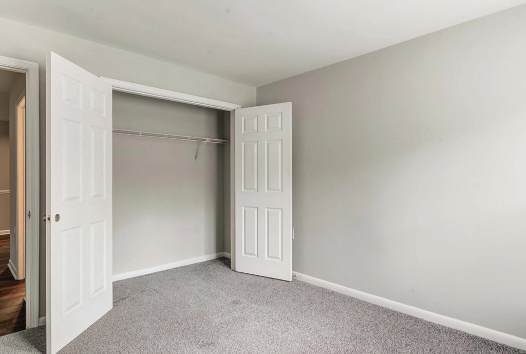 A room with a white door and a grey carpet at Park at Winterset Apartments, Maryland