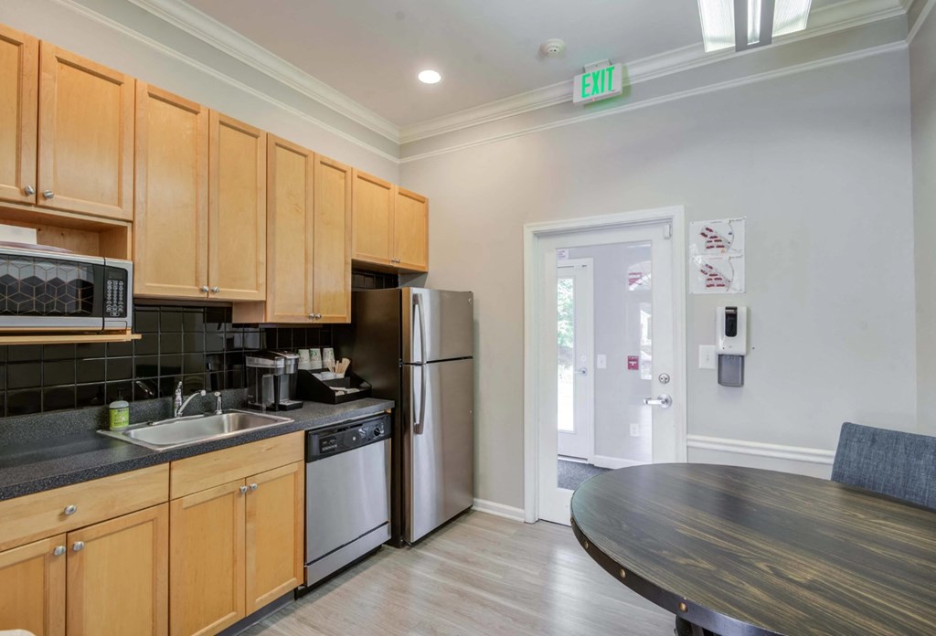A kitchen with wooden cabinets and a black countertop at Park at Winterset Apartments, Owings Mills, Maryland