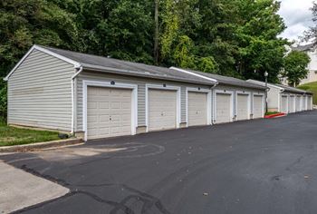 A long row of garages with trees in the background at Park at Winterset Apartments, Maryland