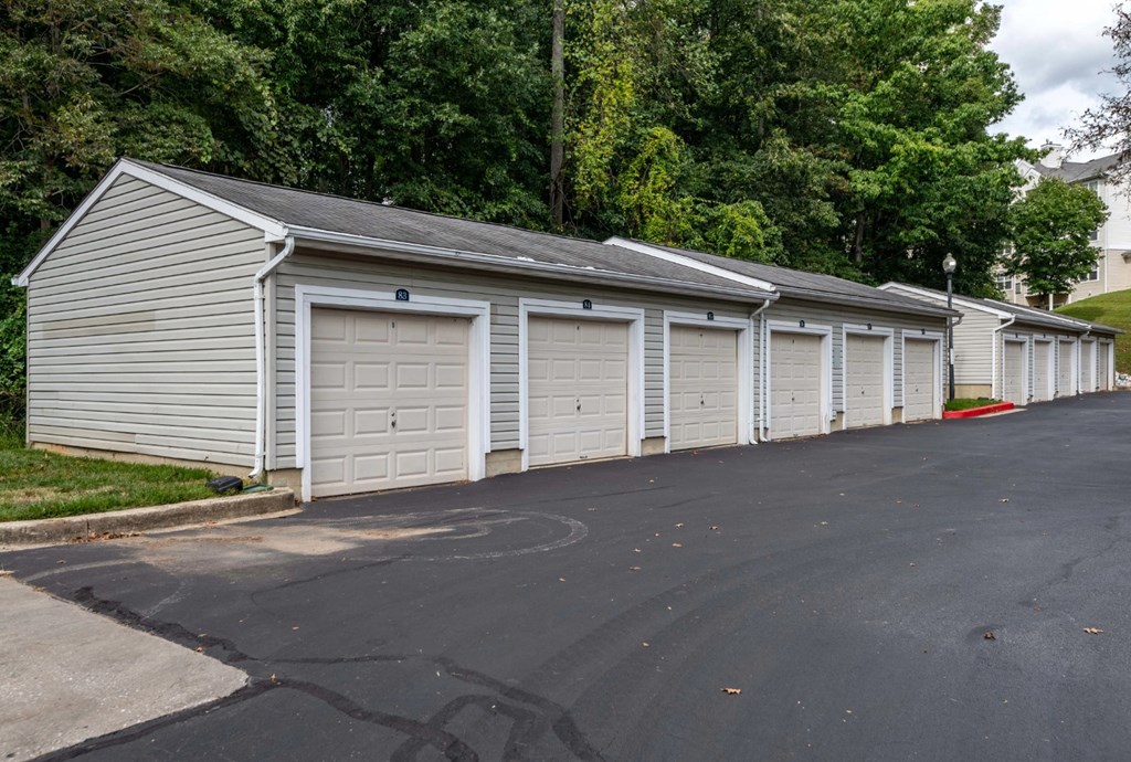 A long row of garages with trees in the background at Park at Winterset Apartments, Owings Mills