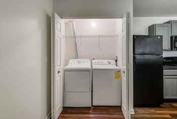 A small laundry room with a washer and dryer at Park at Winterset Apartments, Owings Mills 21117