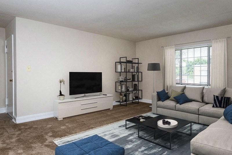 a living room with a couch and a tv at Hamilton Manor Apartments, Maryland