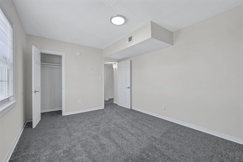 A spacious room with grey carpeting and white walls at Highland Ridge Apartments, Capitol Heights 20743