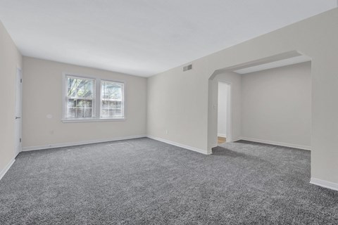 A room with grey carpet and white walls at Highland Ridge Apartments, Capitol Heights