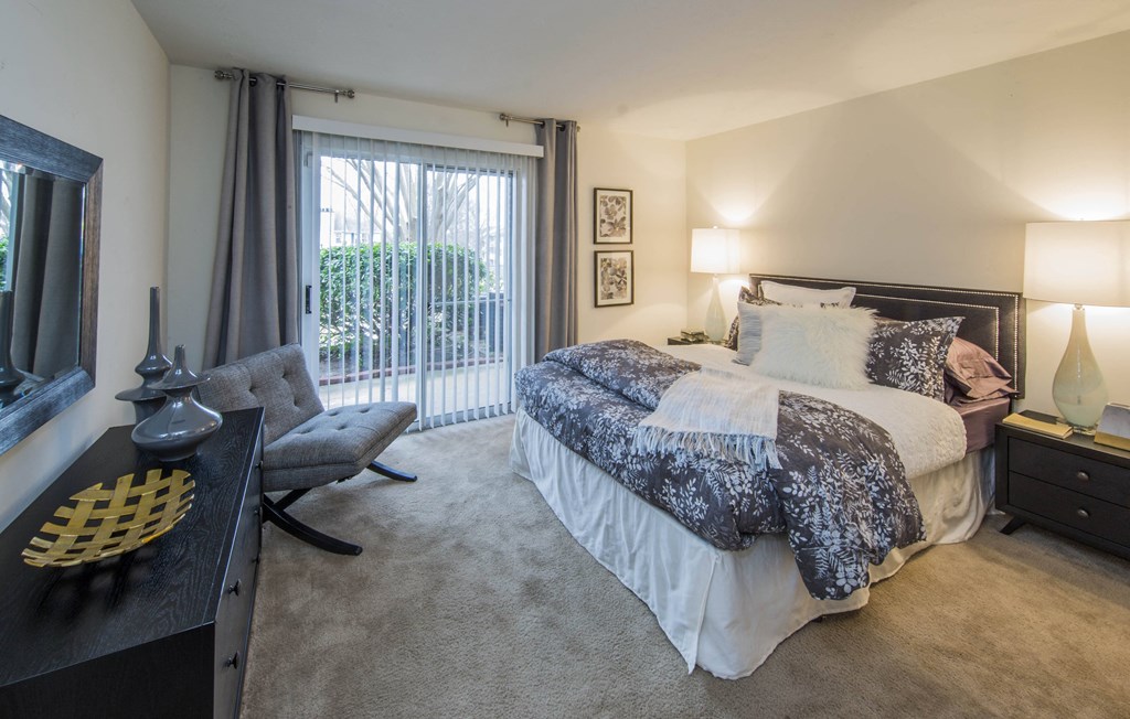a bedroom with a bed and a desk with a chair at Madison at Eden Brook, Columbia Maryland