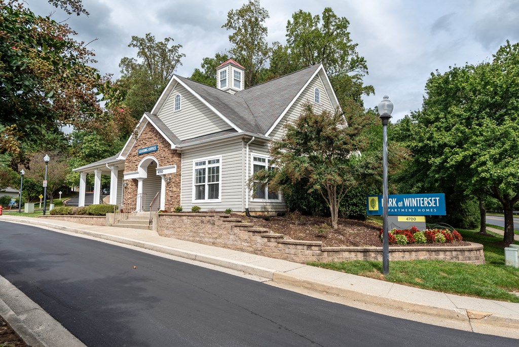 A building with a sign that says "Cedar Creek" in front of it.