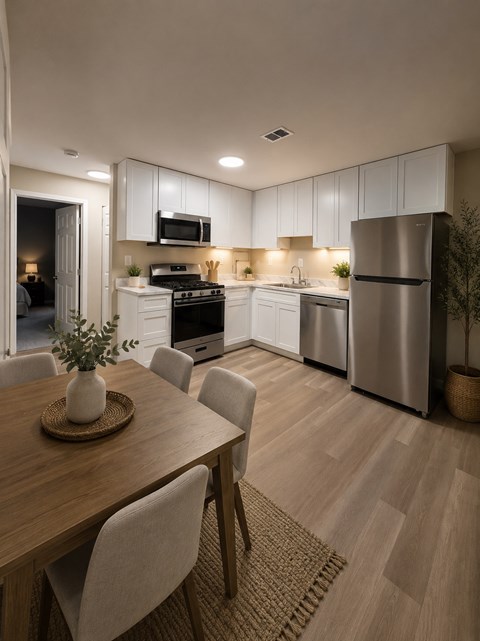 A modern kitchen with a dining table and chairs.