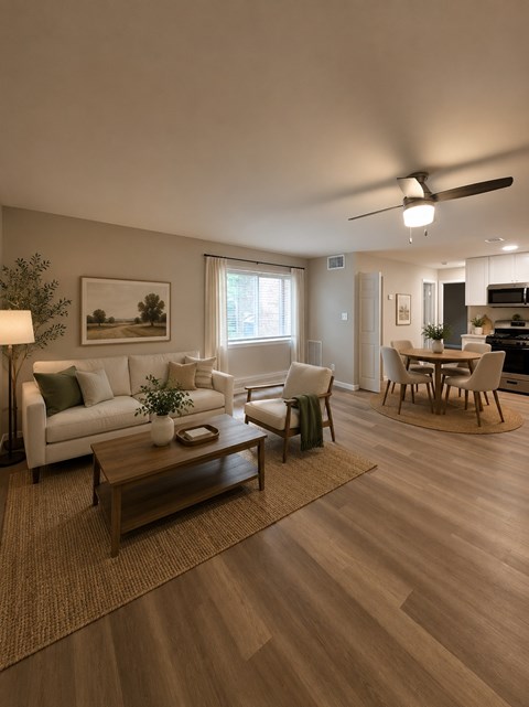 A living room with a white sofa, a wooden coffee table, and a ceiling fan.