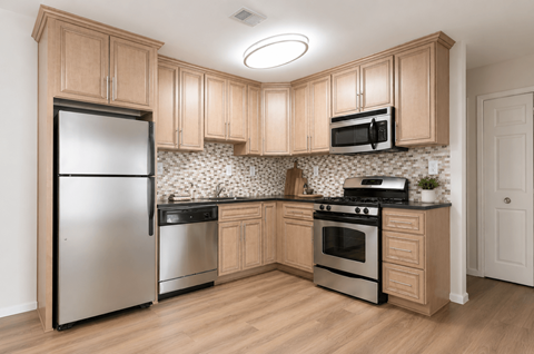 A kitchen with wooden cabinets and stainless steel appliances.