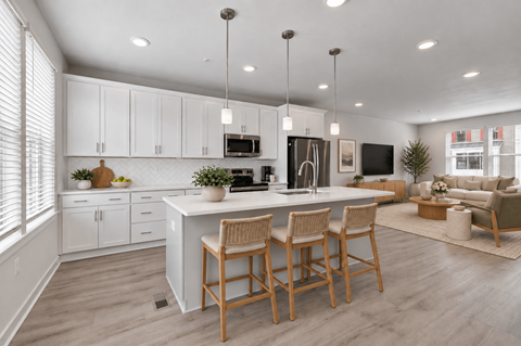 A modern kitchen with white cabinets and a center island.