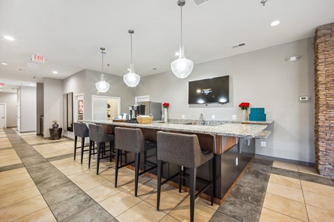 a long bar with chairs and a counter top in a lobby at Villages at Morgan Metro, Landover