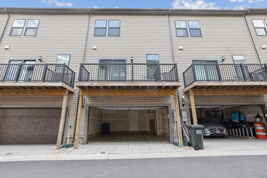 the front of a condo building with two garage doors at Refinery Row, Baltimore