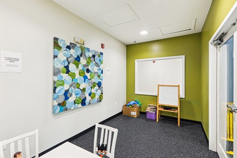 a classroom with a whiteboard and a painting on the wall at Villages at Morgan Metro, Landover