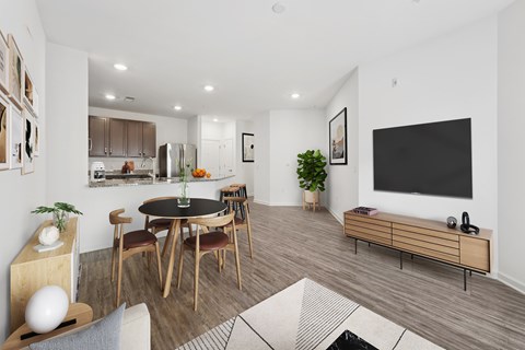 A modern living room with a dining table and chairs.