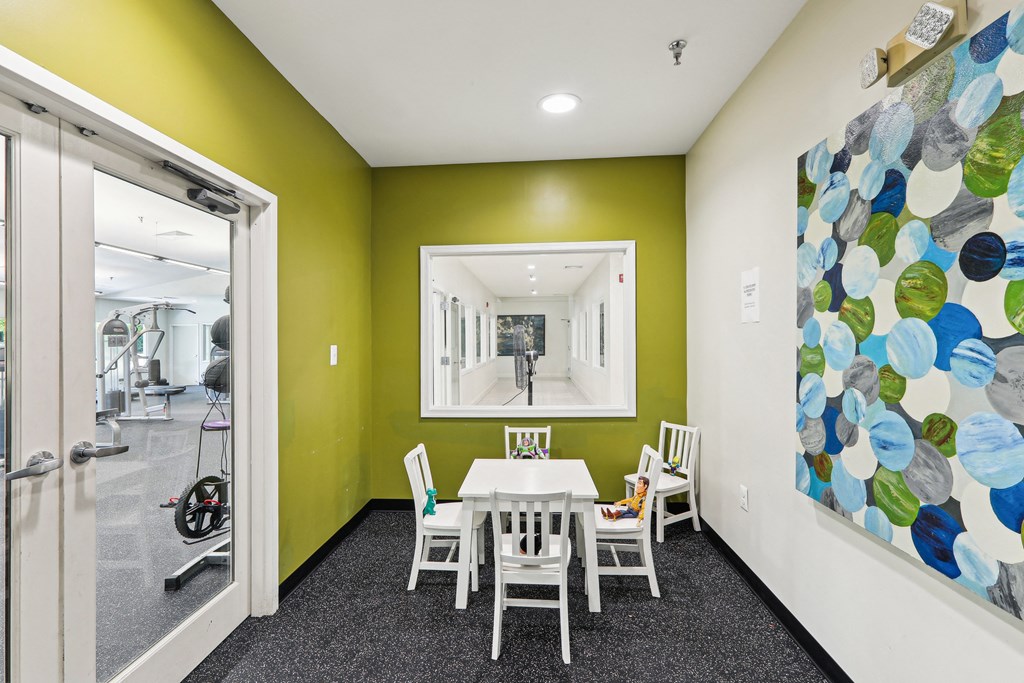 a dining room with a table and chairs and a painting on the wall at Villages at Morgan Metro, Landover, Maryland, 20785