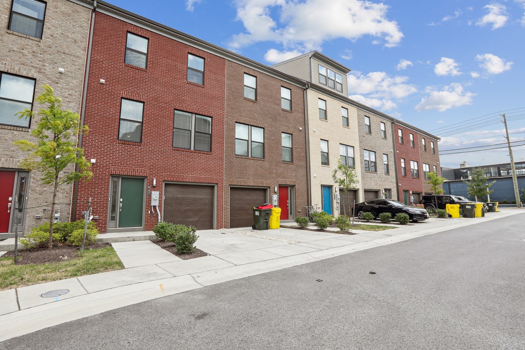 a red brick apartment building with a street in front of it at Refinery Row, Baltimore, 21224