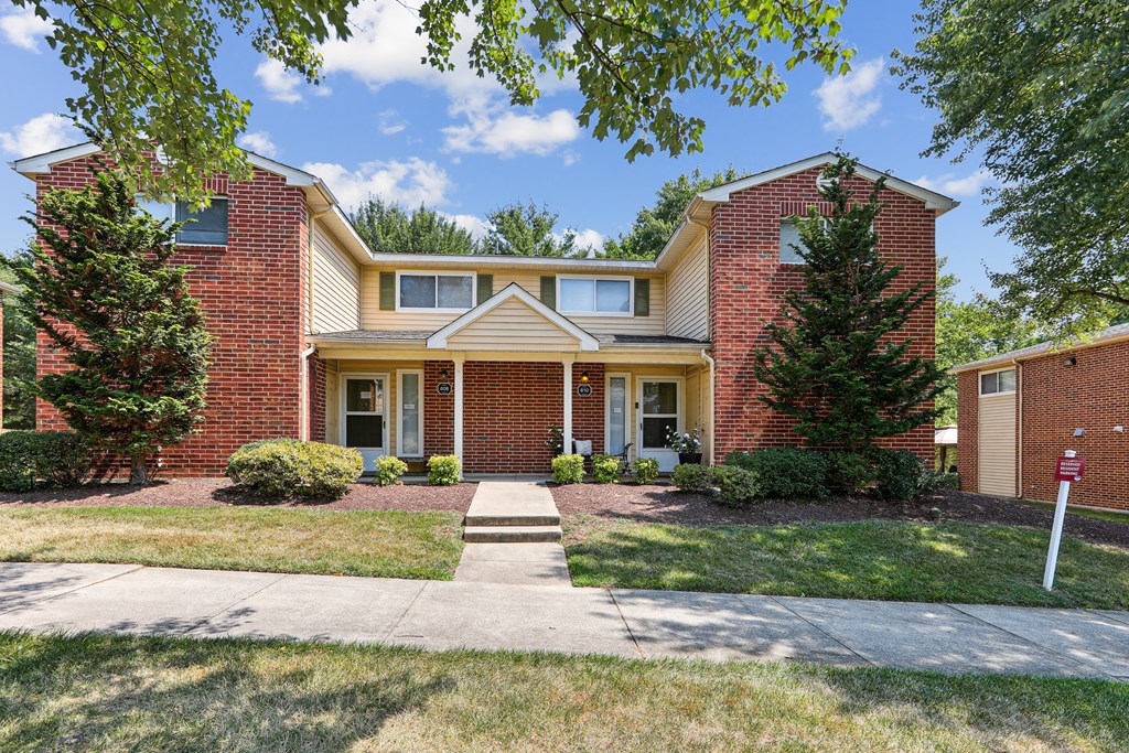 a brick house with a sidewalk in front of it at Villages at Morgan Metro, Landover, Maryland, 20785
