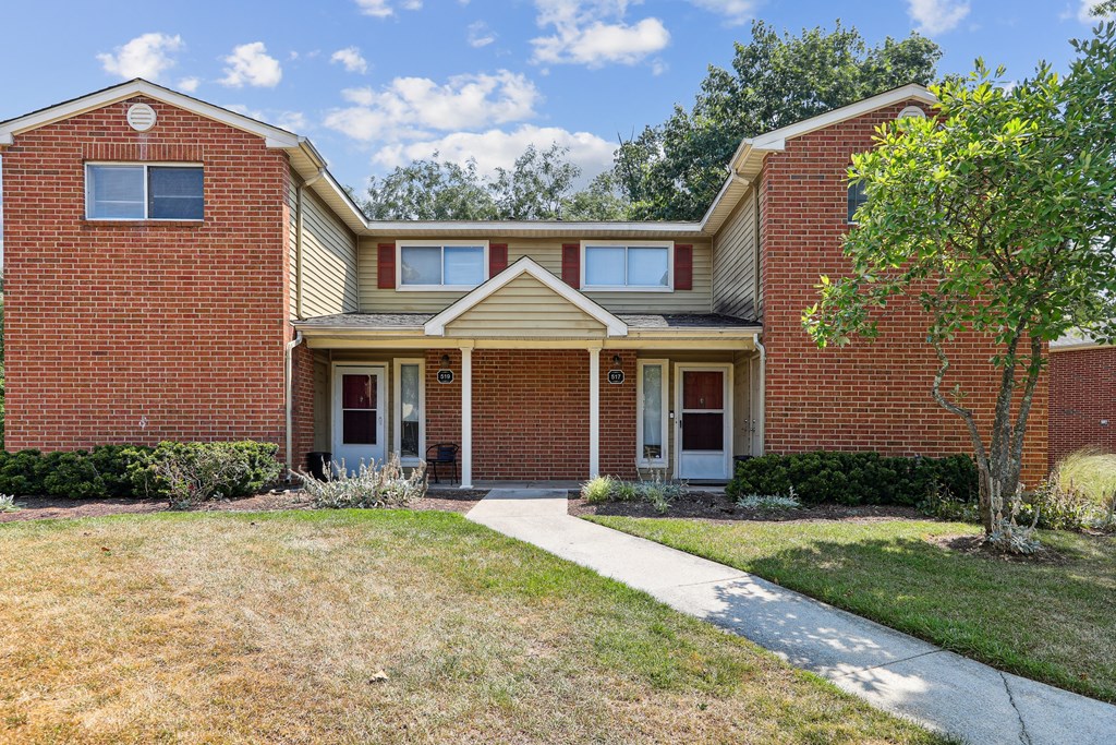 a brick house with a sidewalk in front of it at Villages at Morgan Metro, Landover, MD