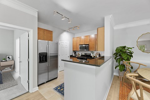 A modern kitchen with wooden cabinets and stainless steel appliances.