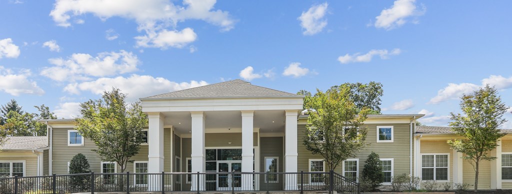 A row of houses with a black fence in front.