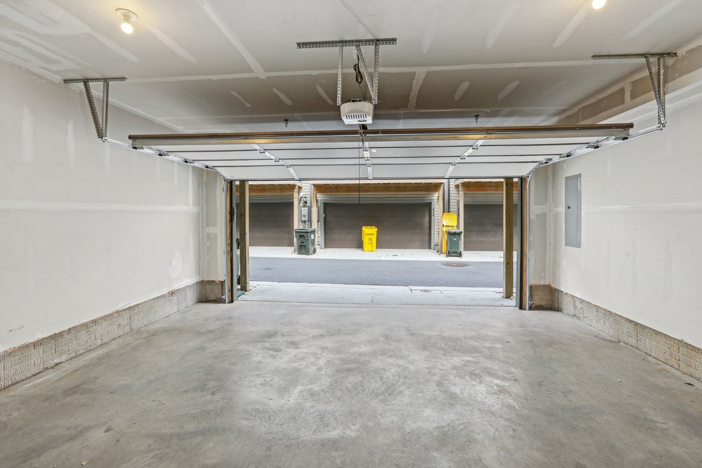 a empty parking garage with white walls and a yellow mailbox at Refinery Row, Baltimore, MD