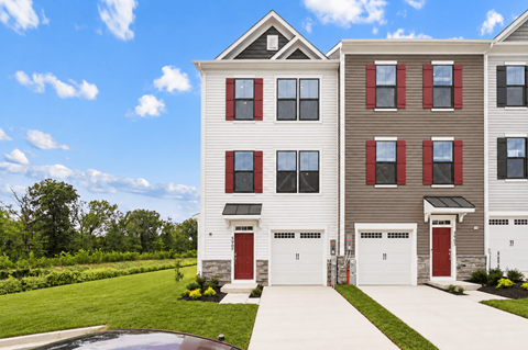 A two-story residential building with a red garage door.