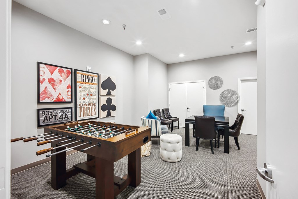 a game room with a foosball table and a dining room table and chairs at Villages at Morgan Metro, Landover, 20785