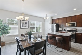 Kitchen and Dining area with wood floors at Townes at Pine Orchard, Ellicott City, 21042 - Photo Gallery 6