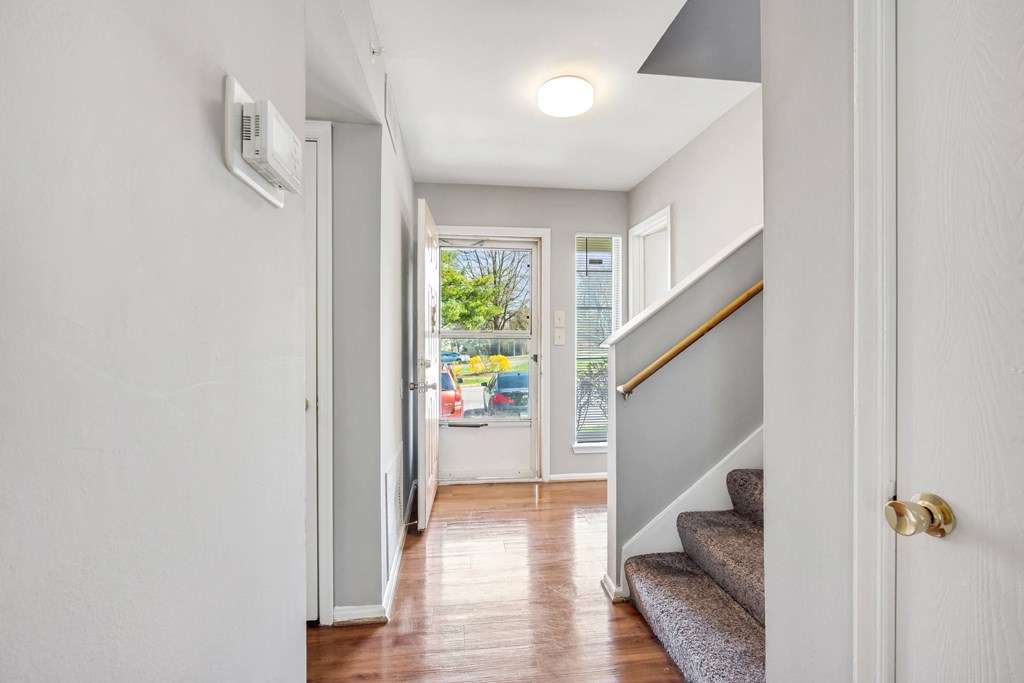 the entrance to a house with stairs and a door to a hallway with a window  at Villages at Morgan Metro, Landover, MD 20785