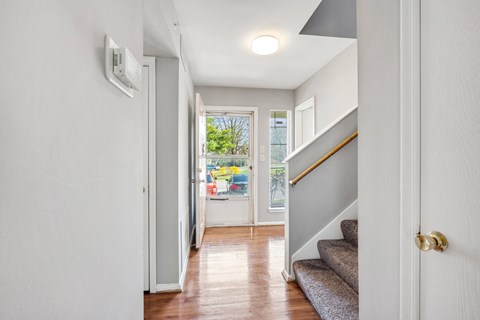 the entrance to a house with stairs and a door to a hallway with a window  at Villages at Morgan Metro, Landover, MD 20785