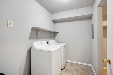 a laundry room with two washers and a dryer in a house at Villages at Morgan Metro, Maryland