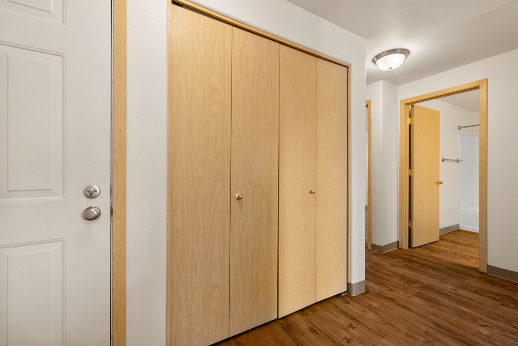 a bedroom with two closets and a door to a hallway