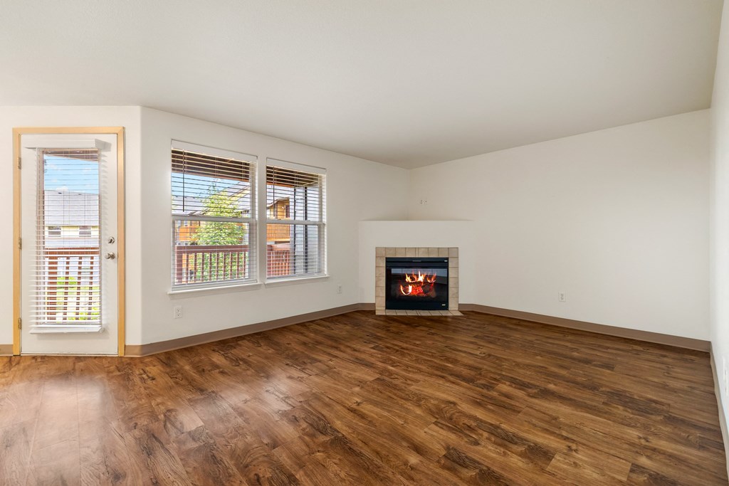 the preserve at ballantyne commons living room with wood flooring and a fireplace