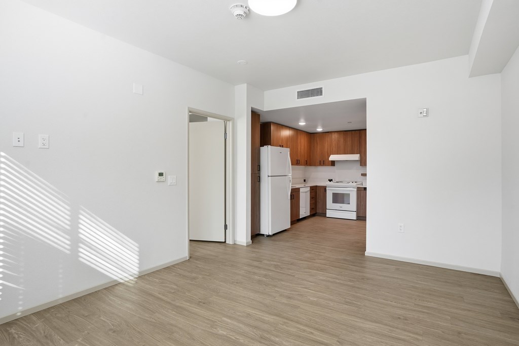 A kitchen with white appliances and wooden cabinets is shown.