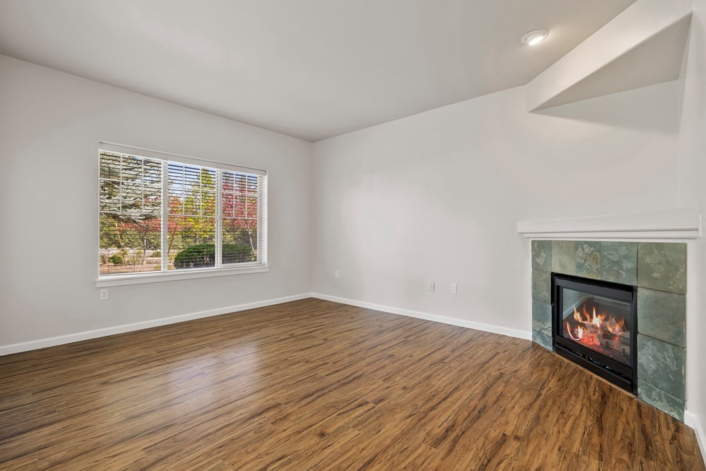a living room with a fireplace and a window